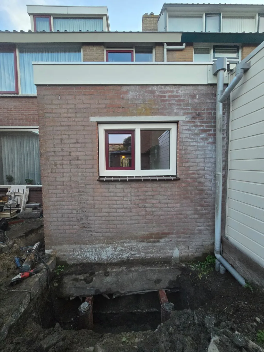 Aanbouw met consolepalen die vanaf de buitenzijde zijn aangebracht: de ontgraving loopt langs de gevel, binnen is niets gesloopt